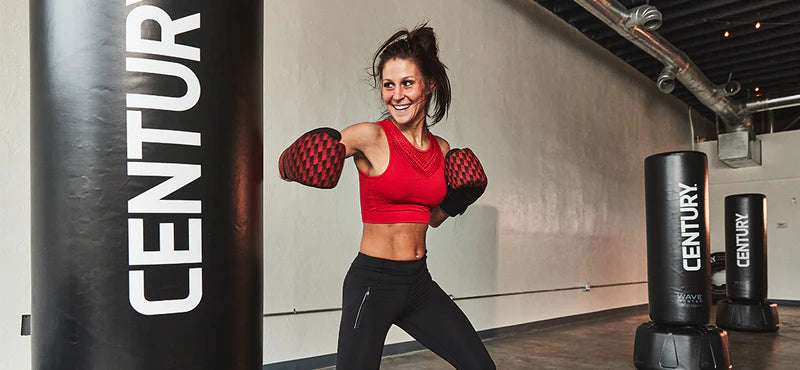 woman punching freestanding bag