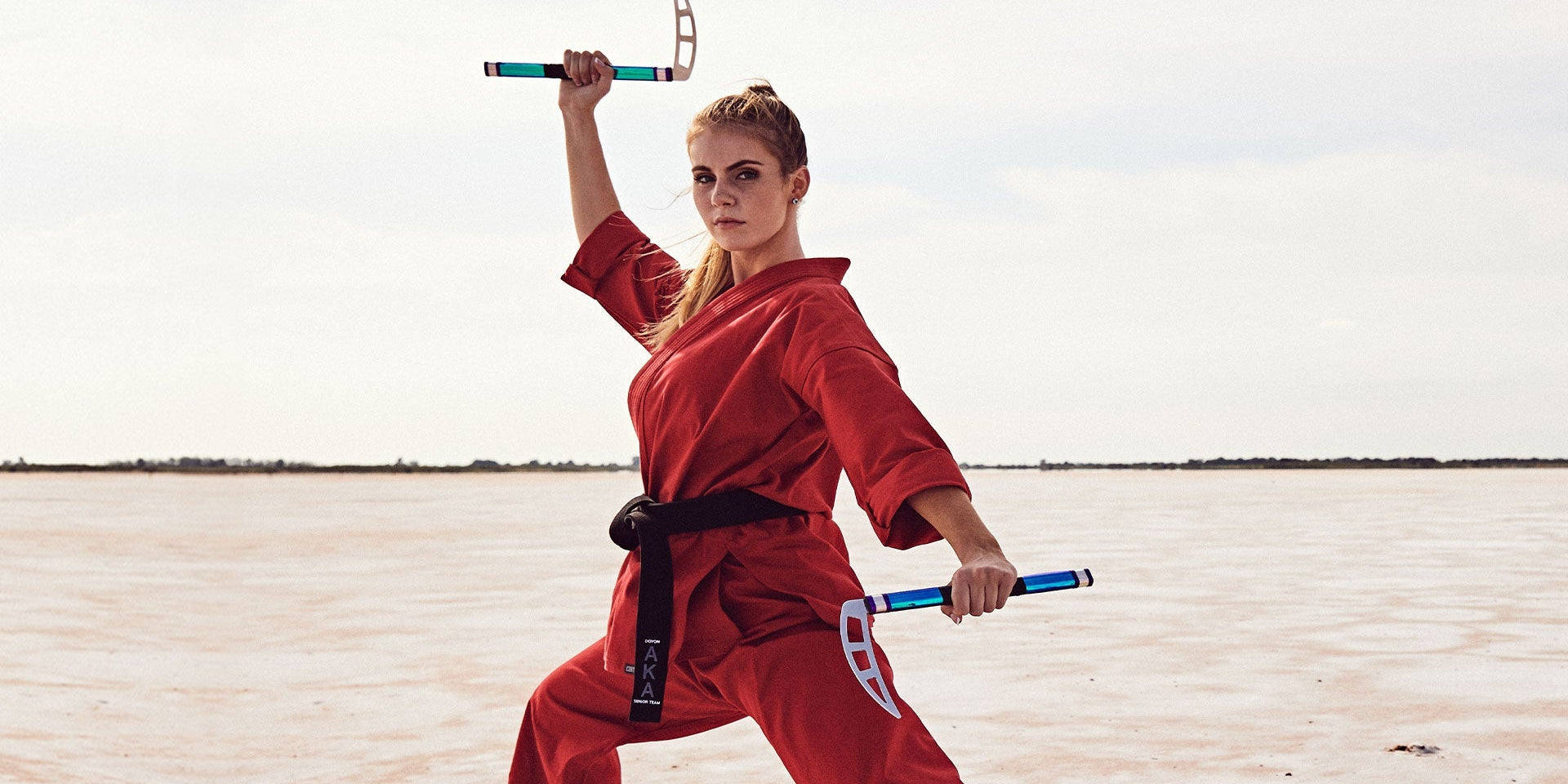 woman training in martial arts with kamas