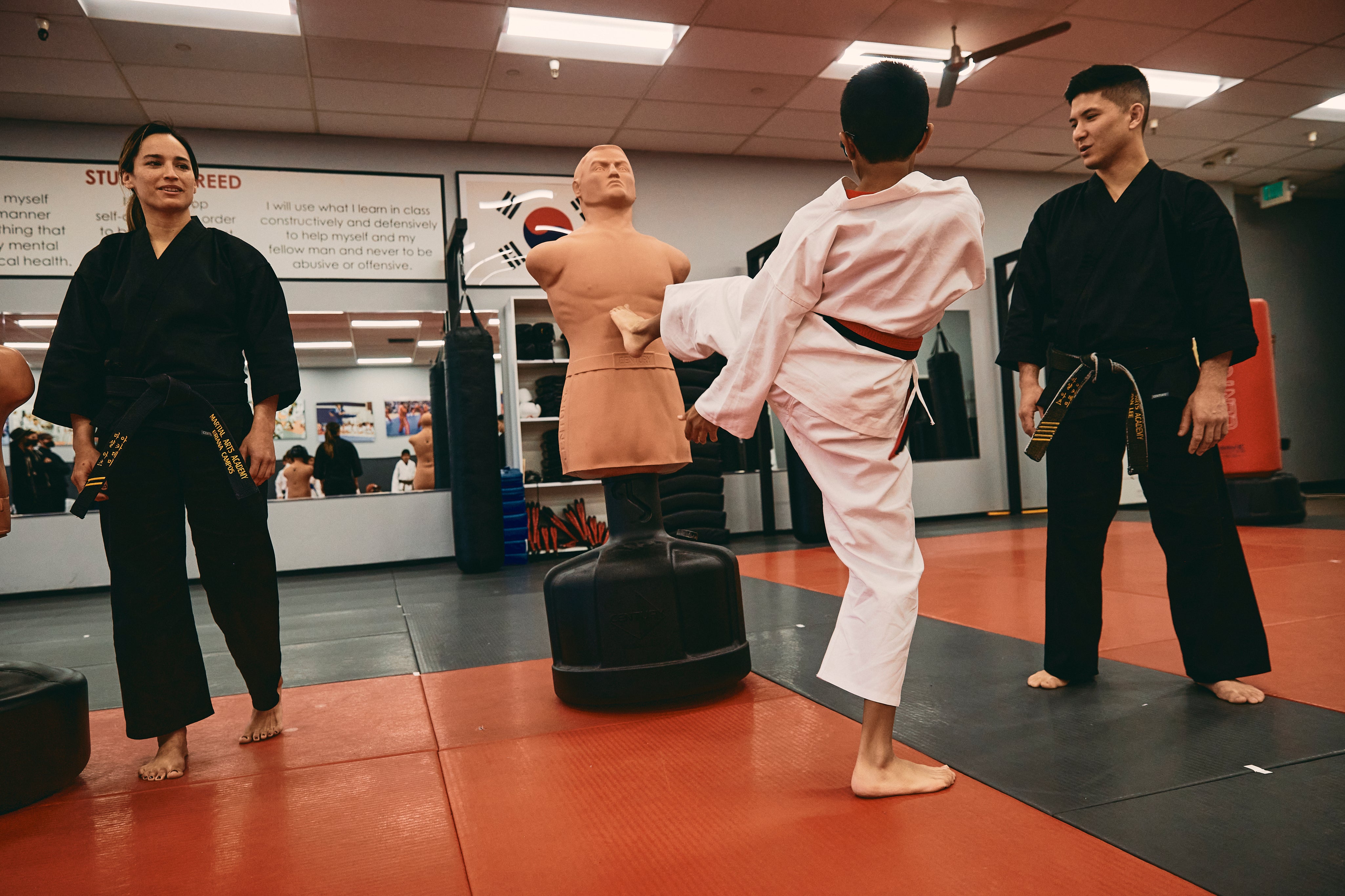 bobxl in a martial arts studio with kid kicking