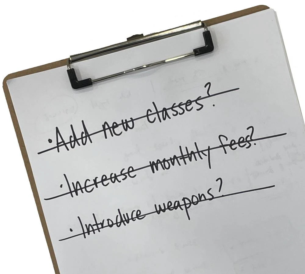 martial arts school objectives on a clipboard