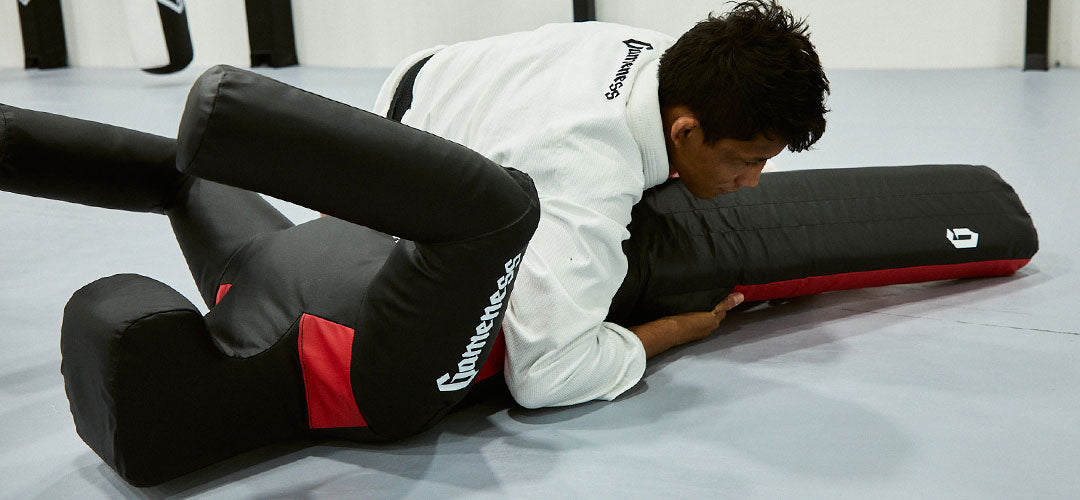martial artist grappling dummy in class