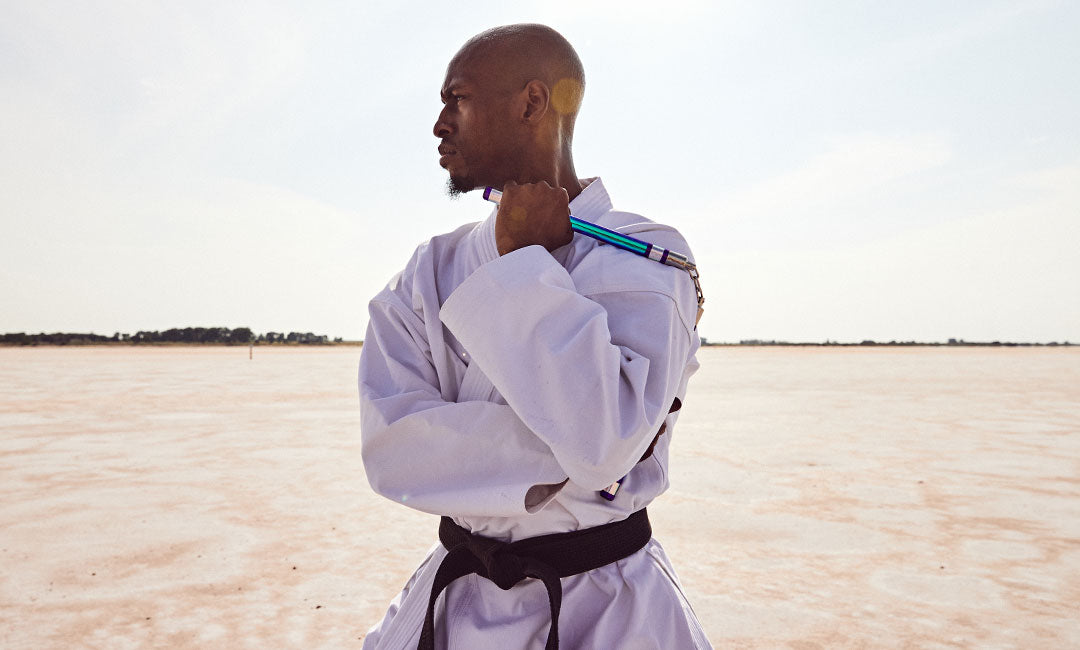 martial artist with nunchuks outside