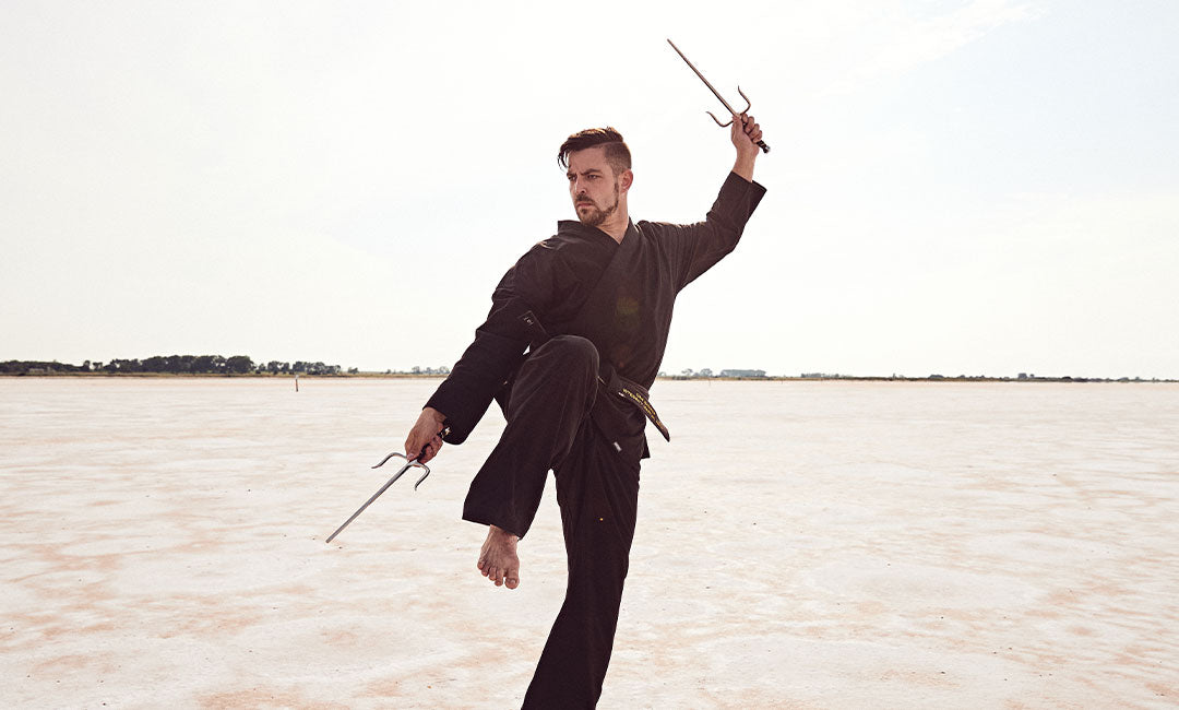 martial artist with sai outside