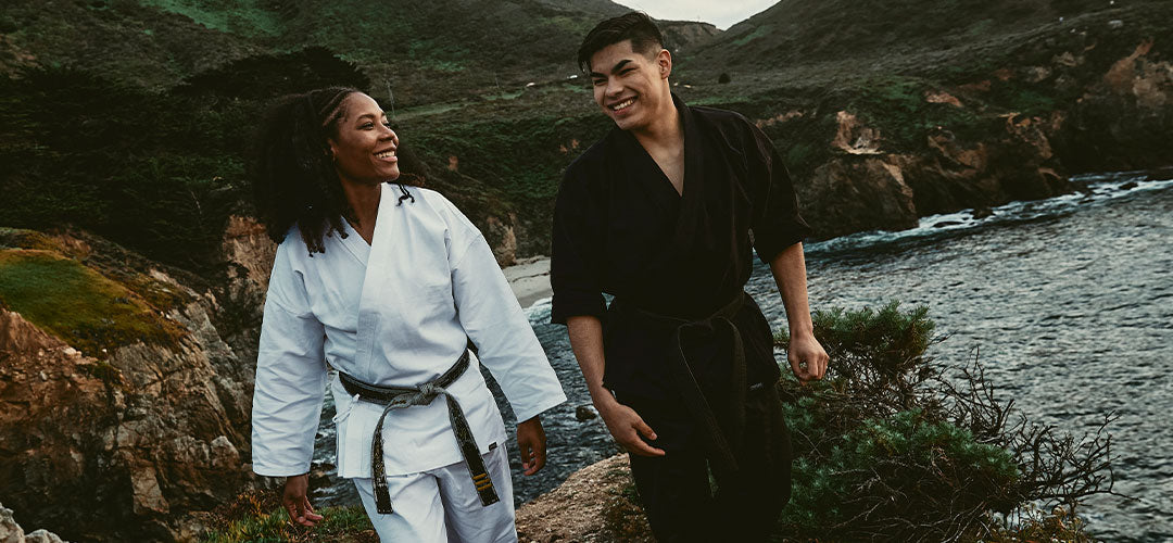 martial artists next to ocean