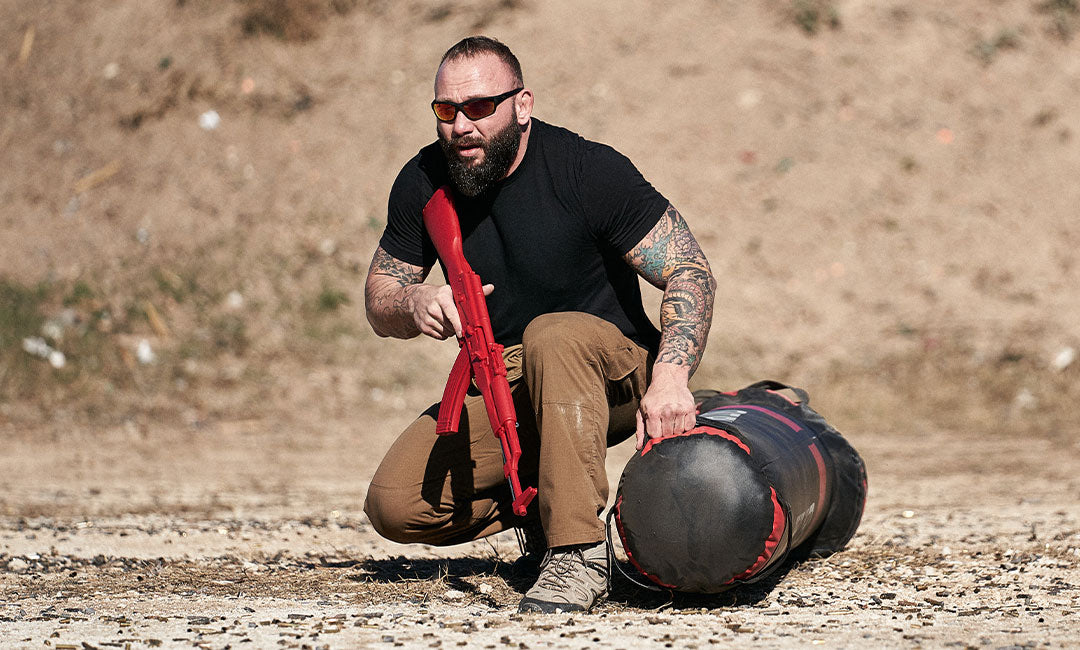 man with training tactical weapons outside