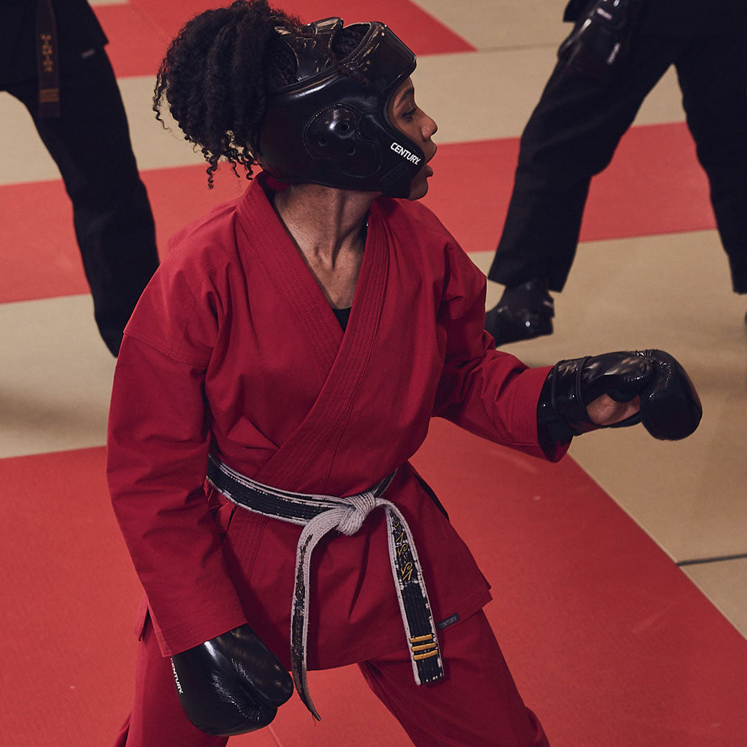 martial artist wearing black belt and protective gear