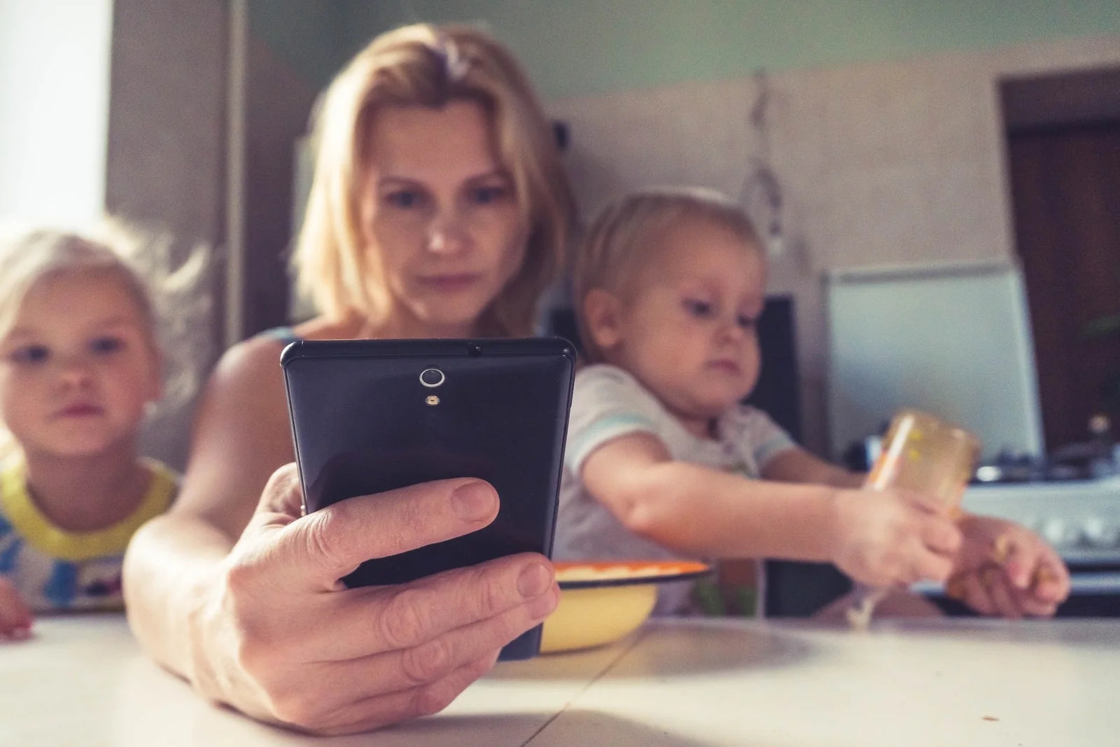 mom on phone with kids